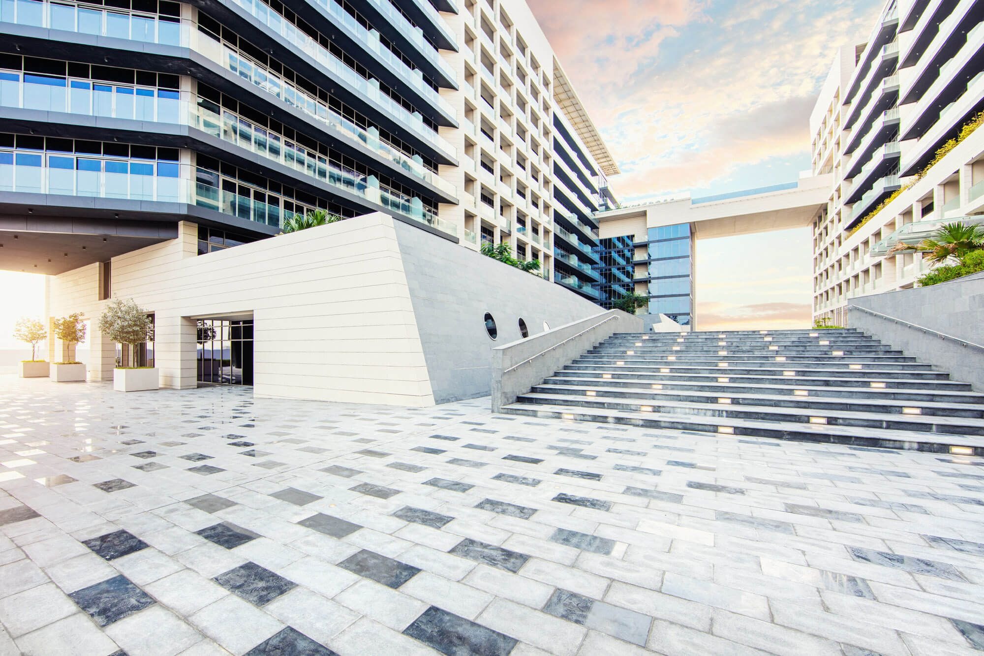 Sunset view of Park View towers reflecting warm light on glass facades in Saadiyat Island, Abu Dhabi.
