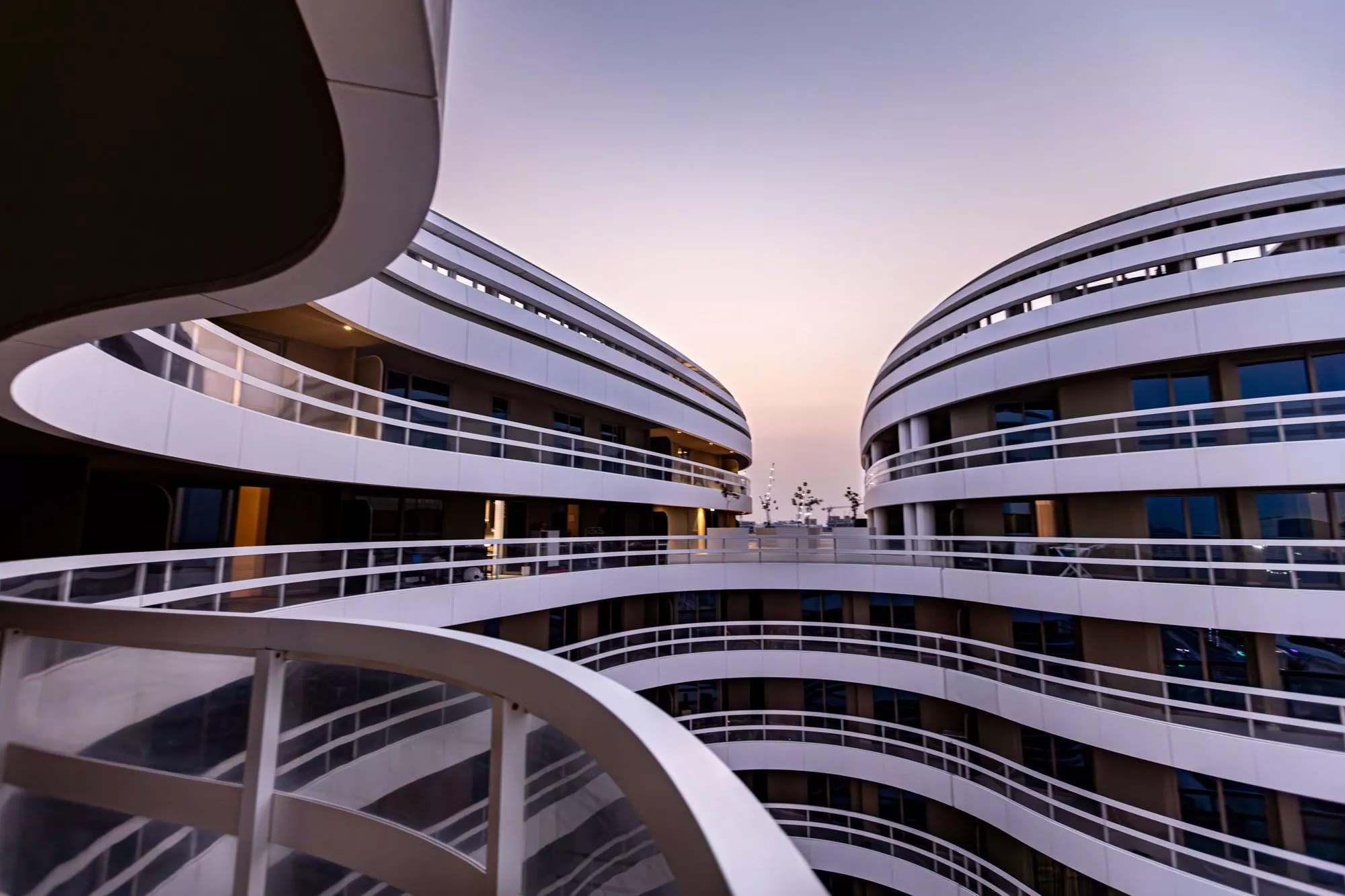 Architectural detail of Ajwan Towers showcasing wave-like curves and contemporary elegance in Abu Dhabi.